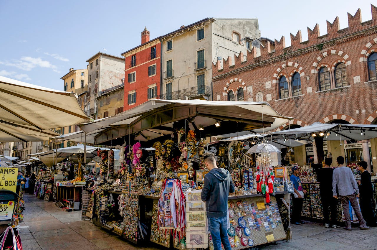 portfolio-03 Lively street market scene in Verona, showcasing local crafts and architecture.