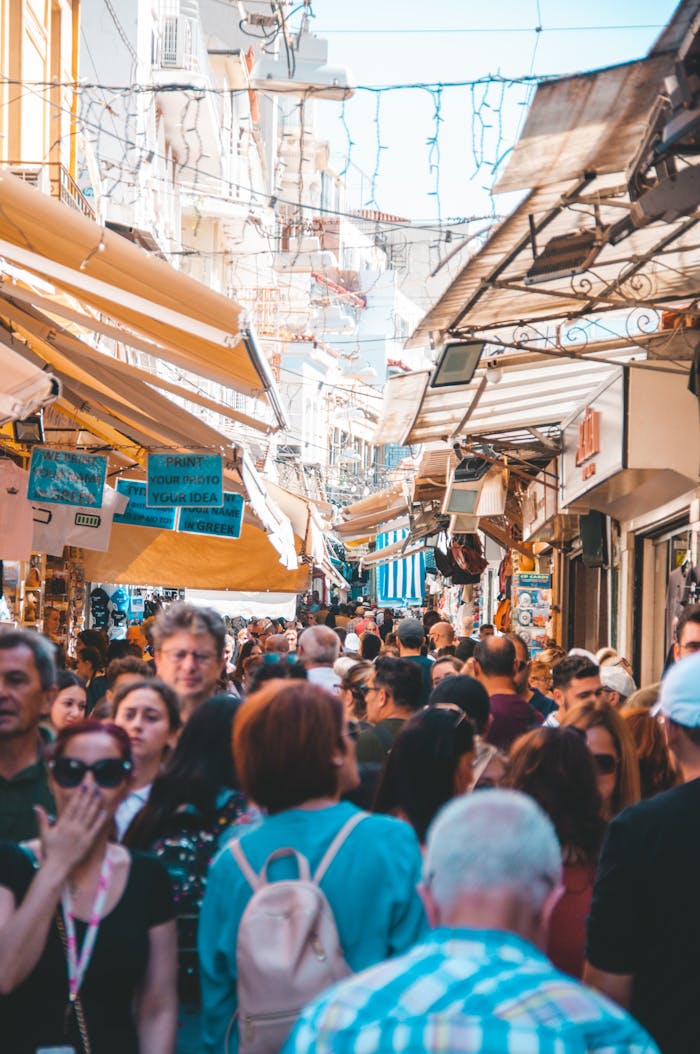 portfolio-04 Bustling street market in Athens with diverse crowd and lively atmosphere.